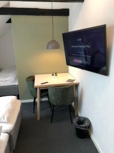 a room with a desk and a bed and a desk and a tv at Go Sleep Vandel in Vandel