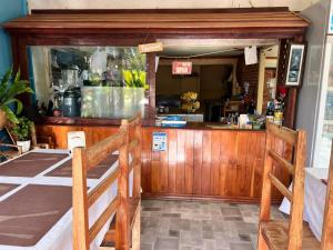 a restaurant with a bar with a counter at Somphamit Guesthouse in Ban Khon