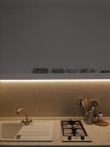 a kitchen counter with a sink and a stove at Casa Quieta in Marina di Camerota +27 photos