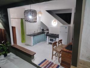 a small kitchen with a table and a dining room at Casa do Artista in Trancoso +13 photos