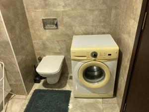 a bathroom with a washing machine and a toilet at Golden Rose Suit in Istanbul