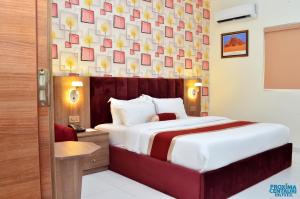 A bed or beds in a room at Proxima Centauri Hotel