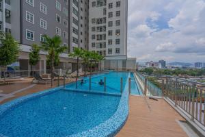 a swimming pool with people playing in it in front of a building at Spacious 3-bedroom condo for 5 Pax @ Titiwangsa Sentral KL in Kuala Lumpur