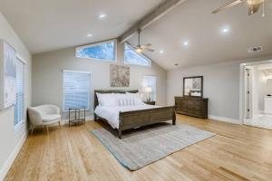 a bedroom with a bed and a chair in it at NEW 4 BDRM Home off St Mary’s Mins To Pearl/River! in San Antonio