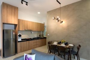 a kitchen and dining room with a table and chairs at Spacious 3-bedroom condo for 5 Pax @ Titiwangsa Sentral KL in Kuala Lumpur