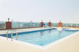 a swimming pool on the roof of a building at Calm&Cozy1BR- Dubai Silicon Oasis-15min-Dxb airpt in Dubai