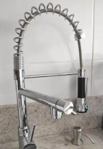 a metal faucet over a sink in a bathroom at Apartamento encantador no Gonzaguinha! Todo Reformado!! Completo! in São Vicente