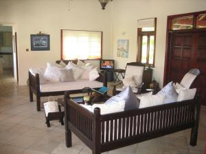 a living room with two couches and a couch at Bartholomew Villas in Saint Georgeʼs