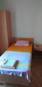 a small bedroom with a bed with a pillow at Apartment Matkovic in Tivat