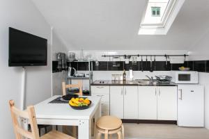 a kitchen with a table with a bowl of fruit on it at Apartments Heart of Dubrovnik in Dubrovnik