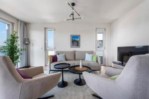 a living room with a couch and chairs and a table at Karl und Anton Boutique Apartments in Vienna