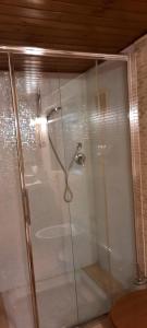 a shower with a glass door in a bathroom at Villa Barone in Selva di Fasano