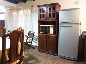 a kitchen with a refrigerator and a cabinet with a microwave at Romance de Luna in San José +2 photos