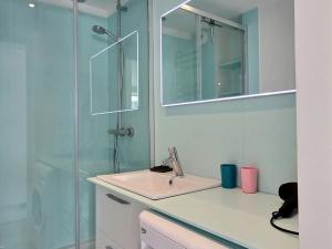 a bathroom with a sink and a glass shower at Appartement spacieux rénové avec WiFi et au pied des pistes - FR-1-455-11 in La Plagne +14 photos