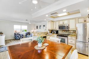 a kitchen with a wooden table and a refrigerator at Beach Villa 1B in Holmes Beach