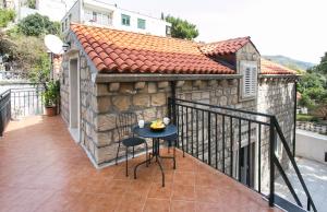 a patio with a table and chairs on a balcony at Apartments Heart of Dubrovnik in Dubrovnik