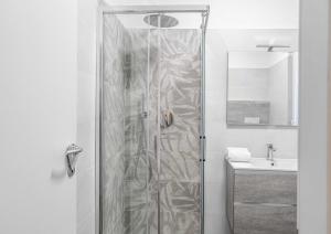 a shower with a glass door in a bathroom at 2 Bedrooms Apt with Terrace - NoLo area in Milan