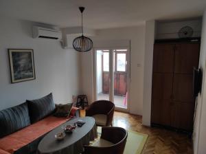 a living room with a couch and a table and chairs at Trg in Kolašin