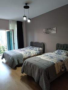 a bedroom with two beds and a window at Nur Sena's House in Istanbul