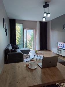 a living room with a table with a laptop on it at Nur Sena's House in Istanbul