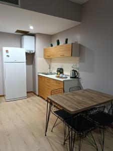 a kitchen with a table and a white refrigerator at Nur Sena's House in Istanbul