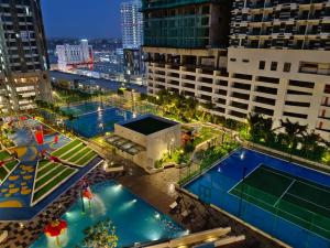 an overhead view of a building with two swimming pools at Bali Residences Homestay Melaka Town in Melaka