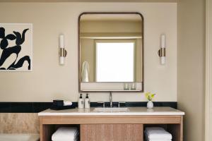 a bathroom with a sink and a mirror at Four Seasons Hotel Miami in Miami