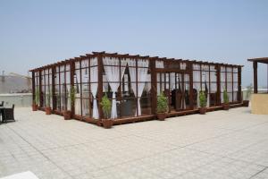 a greenhouse with potted plants in it on a roof at Concorde Hotel Fujairah in Fujairah