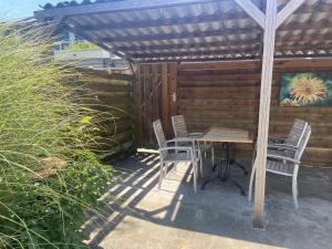 a wooden table and chairs on a patio at Cozy Dutchie House Near Utrecht in Nieuwegein