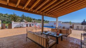 a patio with a table and a swimming pool at El Molino de María Archidona by Ruralidays in Archidona