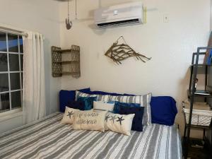 a bedroom with a bed with pillows on it at The Blue Bahia Resort In Sandy Bay in Coxen Hole