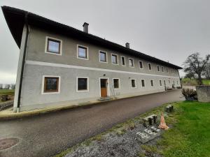 a large white building with a lot of windows at Schöne Wohnung am Bauernhof 