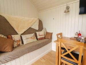 a room with a couch with pillows on it at Hillside View in Rhayader