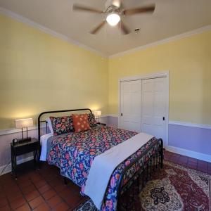a bedroom with a bed and a ceiling fan at Art and Lodging in South Bend