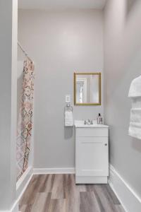 a white bathroom with a sink and a mirror at G3 central location museums FREE PARKING in Richmond
