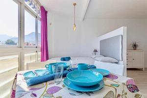 a table with blue dishes on top of it in a room at 797 Holiday Rentals- Moderno, céntrico y espacioso estudio Benalmádena in Benalmádena