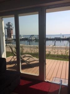 a sliding glass door with a view of the beach at Hafendorf Haus 7 Apartment 5 Nr 89 Parkplatz am Haus in Plau am See