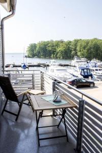 a table and a chair on a balcony with boats at 4 Zimmer Maisonette 3 Balkone Haus 7 A 6 in Plau am See