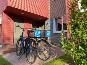a bike parked next to a house with a for sale sign at Hafendorf Haus 5 Apartment 2 Nr25 in Plau am See