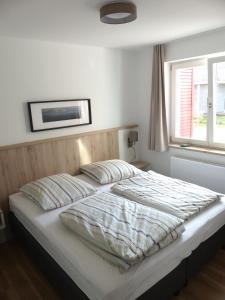 Schlafzimmer mit einem großen Bett und einem Fenster in der Unterkunft Haus 6 Apartment 3 in Plau am See