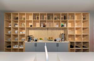 a kitchen with wooden shelves and a counter top at Hotel Light in Rotterdam
