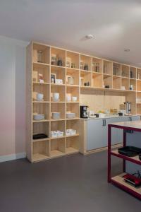 a kitchen with wooden shelves with dishes in it at Hotel Light in Rotterdam