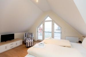 a attic bedroom with two beds and a tv at Apartment mit 3 Schlafzimmer P5A7 in Plau am See