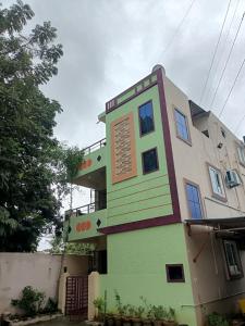 a building with a sign on the side of it at ADVIK HOMESTAYS in Tirupati