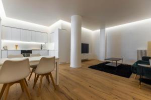 a kitchen and living room with a table and chairs at La Dolce Vita - Luxury Stylish Flats in Trastevere 70-90sqm in Rome