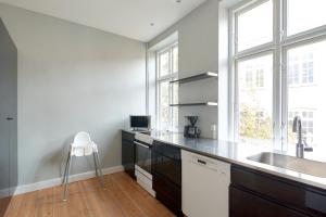 a kitchen with a sink and a counter at Spacious Scandinavian 3BR Flat in Vibrant Area in Copenhagen