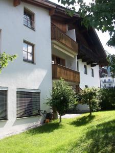 a large white building with a balcony on the side of it at Haus Fuchs in Ehrwald