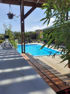 a swimming pool in a backyard with a swing at La kazanou in Saint-Joseph