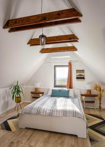 a bedroom with a white bed in a attic at Eged Lodge in Eger