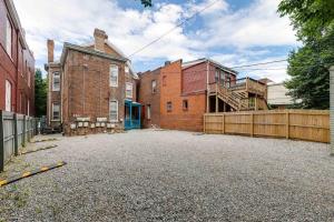 an empty parking lot in front of a brick building at G6 central location museums FREE PARKING in Richmond